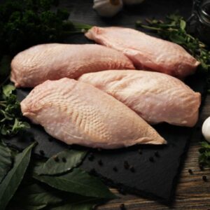 Raw Sommerlad chicken breasts (skin-on), laid out in a neat row, ready for preparation.