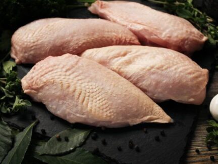 Raw Sommerlad chicken breasts (skin-on), laid out in a neat row, ready for preparation.
