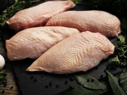 Raw Sommerlad chicken breasts (skin-on), laid out in a neat row, ready for preparation.