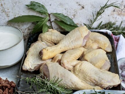 Selection of raw Grassland Sommerlad Heritage chicken portions including wings, marylands, drumsticks, breasts, and offal