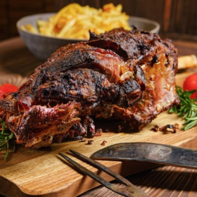 Plate of roasted boar leg with roasted vegetables