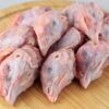 Raw Sommerlad heritage chicken heads arranged on a board
