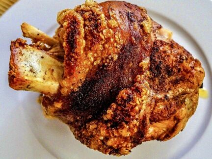 Crisp fried smoked hock from Wuuluman regenerative pastured pork on a white plate.